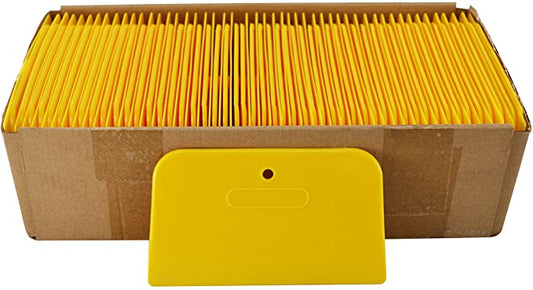 Single yellow 3x6 inch plastic spreader with a hang hole, used for applying body filler or putty, shown against a white background.