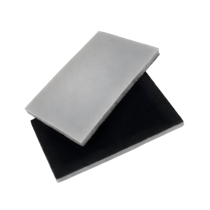 Two rectangular foam filter pads stacked diagonally, one in light gray and one in black, on a plain white background.
