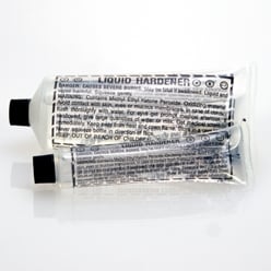 USC 30015 Liquid Hardener (2 oz, Clear), a fast-acting methyl ethyl ketone peroxide (MEKP) catalyst designed to activate and cure polyester-based fiberglass resins, ensuring strong bonding and rapid curing.